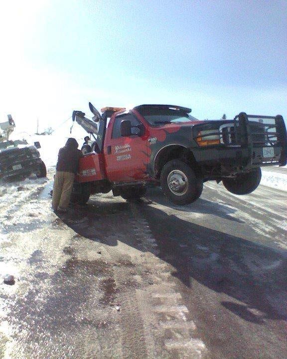 Kirksville Autoworks and Troy Mills Auto towing truck