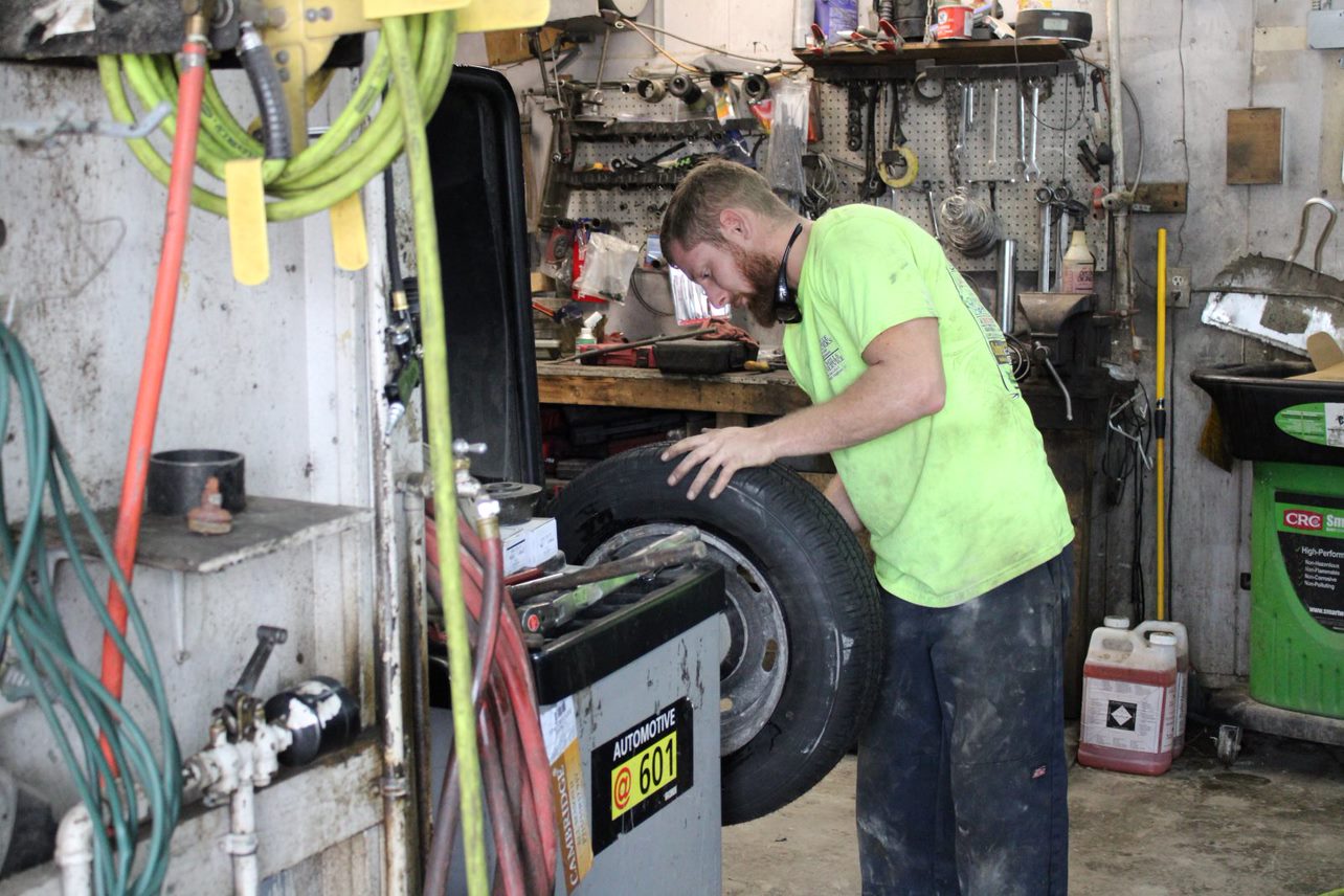 Technician working with a vehicle tire